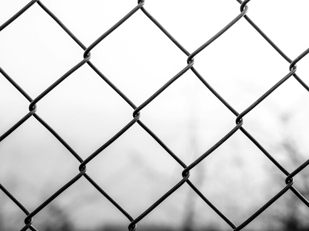 grayscale photo of chain link fence