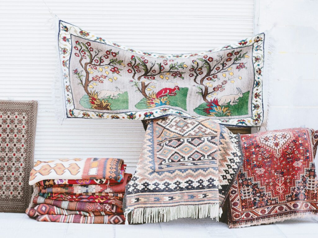 a pile of rugs and pillows sitting next to each other